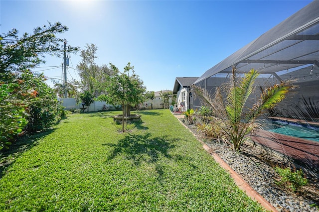 view of yard with a lanai and a fenced in pool