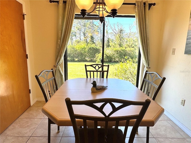 tiled dining area with a notable chandelier