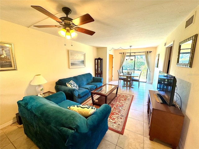 tiled living room featuring ceiling fan