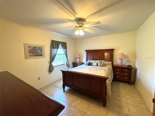 tiled bedroom featuring ceiling fan and a textured ceiling