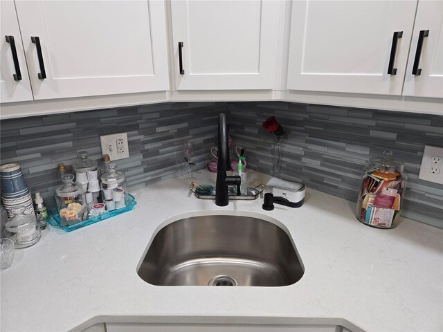 21260 Brinson Ave Unit 307, Port Charlotte, FL 33952 - kitchen view of a sink, white cabinets, and tasteful backsplash