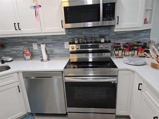 21260 Brinson Ave Unit 307, Port Charlotte, FL 33952 - kitchen featuring stainless steel appliances, light countertops, and white cabinets