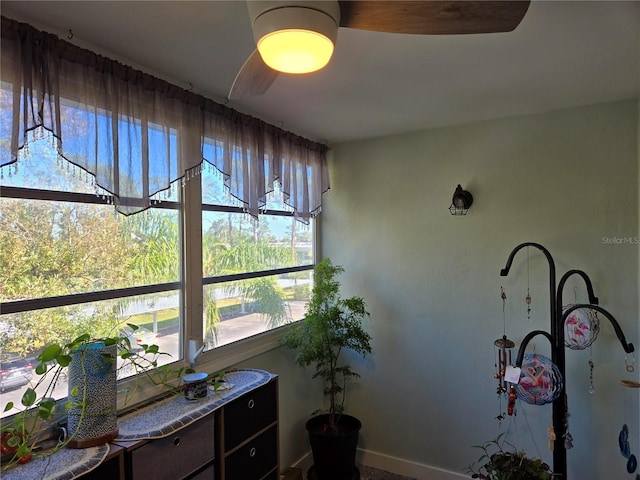 sunroom / solarium featuring plenty of natural light and ceiling fan