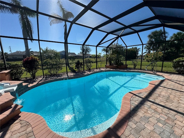 view of swimming pool with a lanai, a patio area, and pool water feature