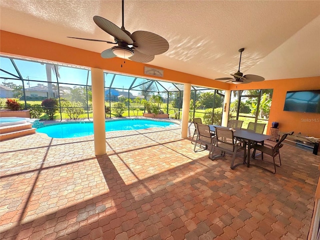 view of swimming pool with a jacuzzi, a patio, ceiling fan, and a lanai