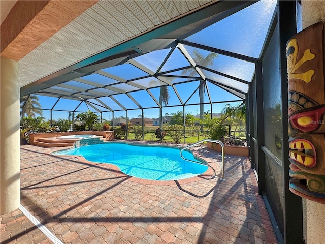 view of pool with glass enclosure, a patio area, and an in ground hot tub