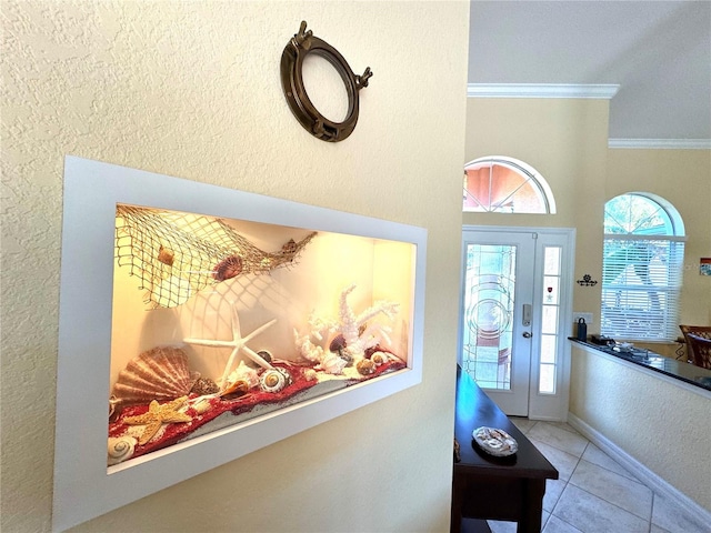 tiled entryway featuring ornamental molding