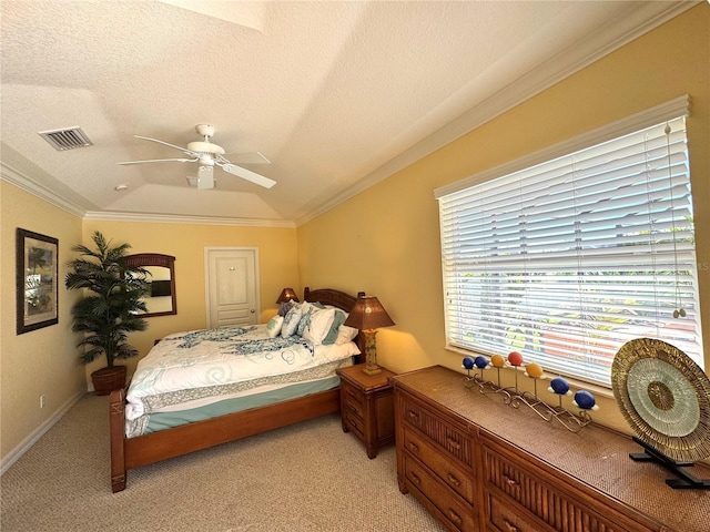 carpeted bedroom featuring ceiling fan, ornamental molding, and a textured ceiling