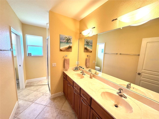 bathroom with tile patterned floors, vanity, and toilet