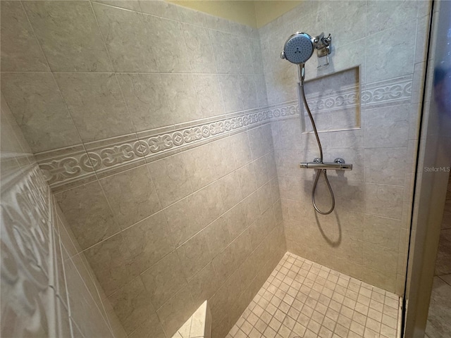 bathroom with tiled shower