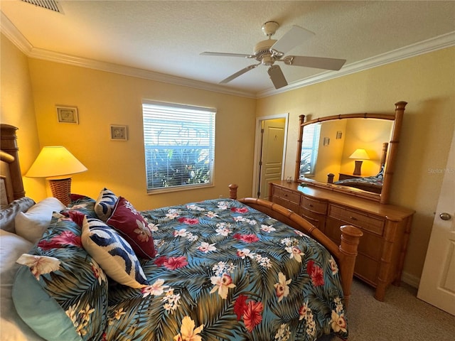 bedroom featuring a textured ceiling, carpet floors, ceiling fan, and ornamental molding