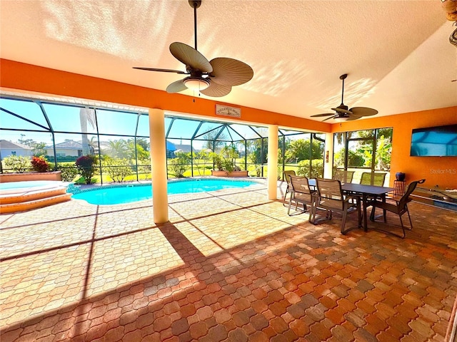 view of swimming pool featuring glass enclosure, a jacuzzi, a patio area, and ceiling fan