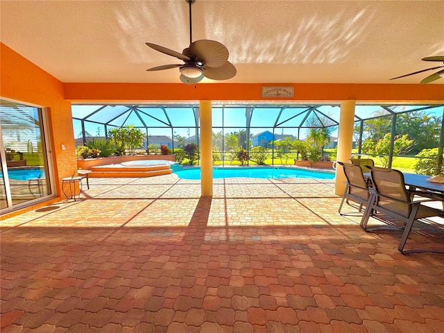 exterior space featuring ceiling fan, a swimming pool with hot tub, and a lanai