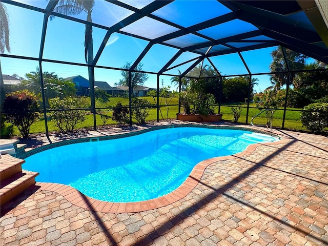 view of swimming pool with a patio and a lanai