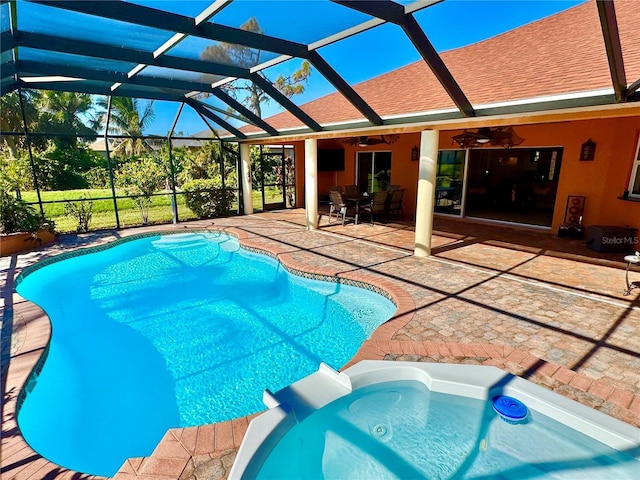 view of pool with an in ground hot tub, a patio, ceiling fan, and a lanai