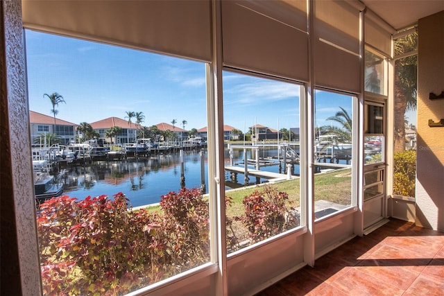 unfurnished sunroom featuring a water view