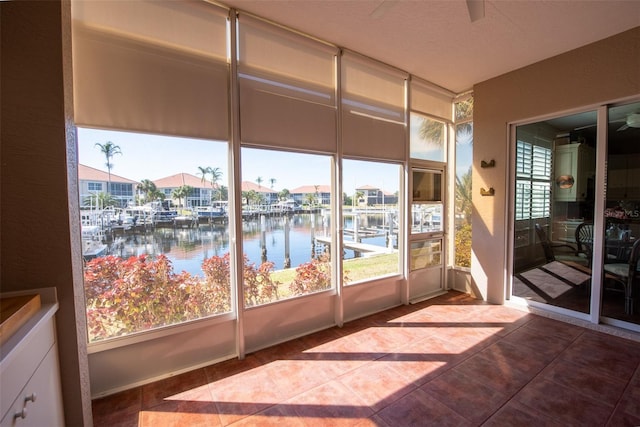 sunroom / solarium with a water view