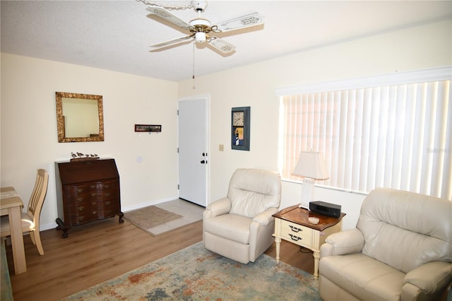 sitting room with light hardwood / wood-style flooring and ceiling fan