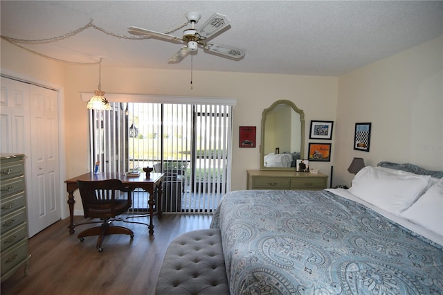 bedroom with access to exterior, dark hardwood / wood-style flooring, a textured ceiling, ceiling fan, and a closet