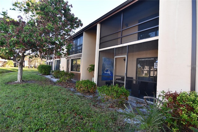 view of side of property with a yard