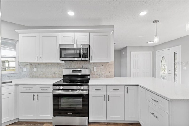 kitchen with white cabinets, stainless steel appliances, and a textured ceiling