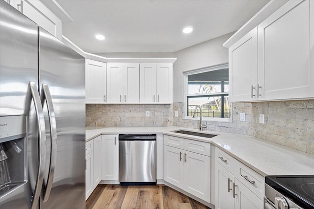 kitchen featuring sink, white cabinets, and appliances with stainless steel finishes