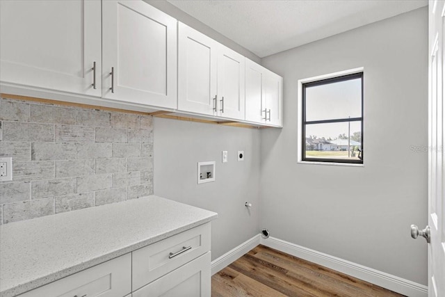 washroom featuring cabinets, washer hookup, electric dryer hookup, gas dryer hookup, and wood-type flooring