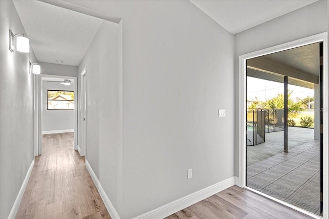 corridor with light hardwood / wood-style flooring