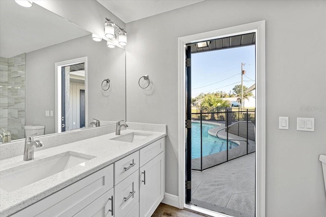 bathroom with hardwood / wood-style floors, vanity, and toilet