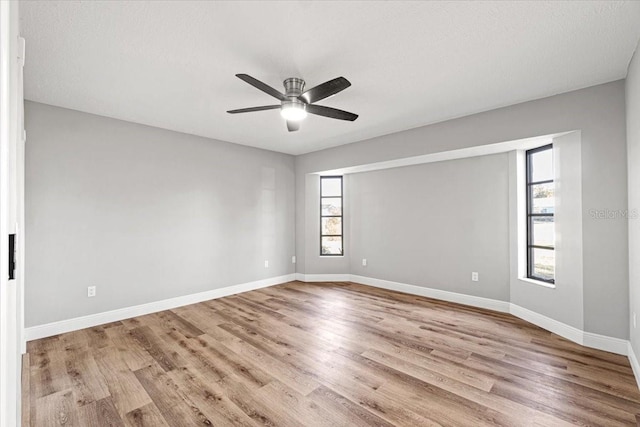 unfurnished room featuring a textured ceiling, light hardwood / wood-style flooring, and ceiling fan