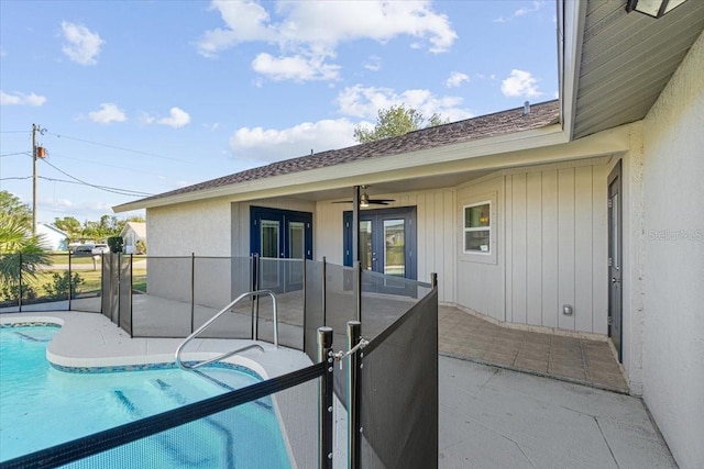 view of pool with french doors and a patio area