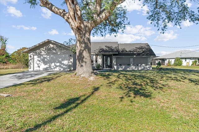 view of front of home with an attached garage, concrete driveway, and a front yard