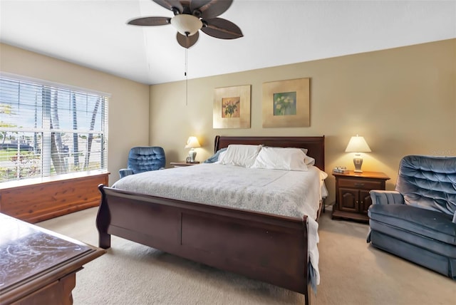 bedroom with ceiling fan and light colored carpet