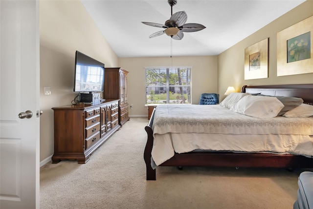 bedroom with light colored carpet, vaulted ceiling, and ceiling fan