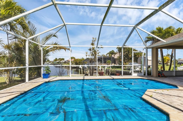 view of pool with a water view and glass enclosure