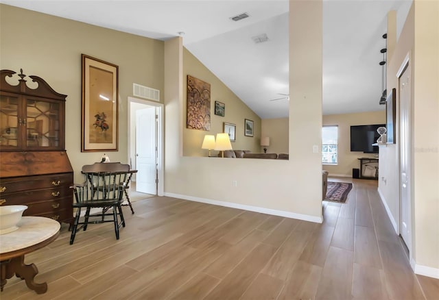 interior space featuring lofted ceiling and wood-type flooring