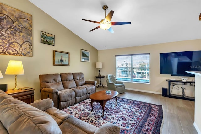 living room featuring light wood-type flooring, vaulted ceiling, and ceiling fan