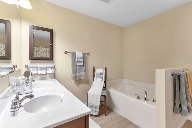 bathroom with a bathing tub and vanity