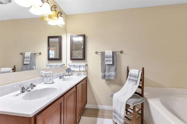 bathroom featuring vanity and a tub to relax in