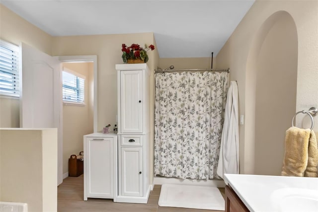 bathroom featuring hardwood / wood-style flooring, vanity, and a shower with shower curtain