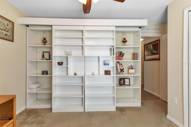 interior space with light carpet and ceiling fan