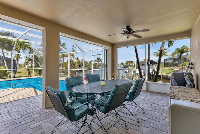 sunroom with ceiling fan and plenty of natural light