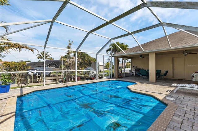 view of pool with a patio, ceiling fan, and a lanai