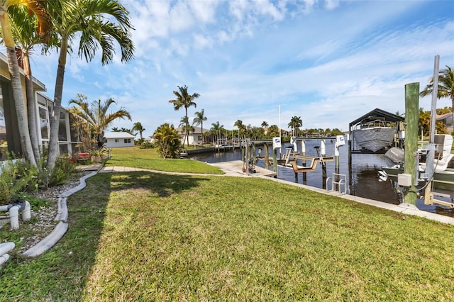 dock area featuring a lawn and a water view