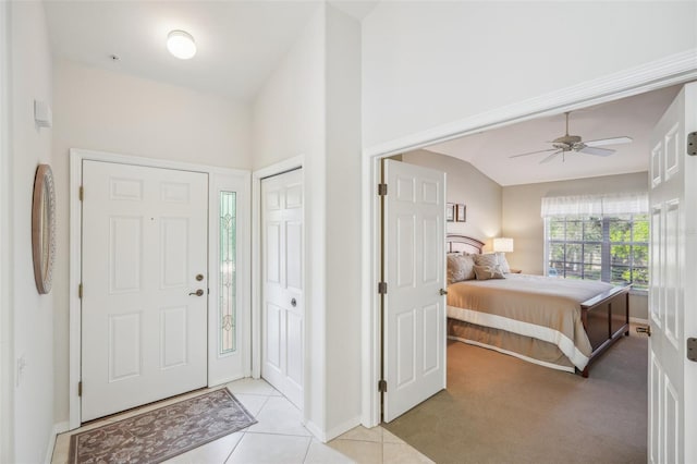 entrance foyer with light carpet, ceiling fan, and lofted ceiling