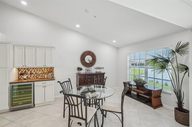 dining area with wine cooler, light tile patterned floors, and indoor bar