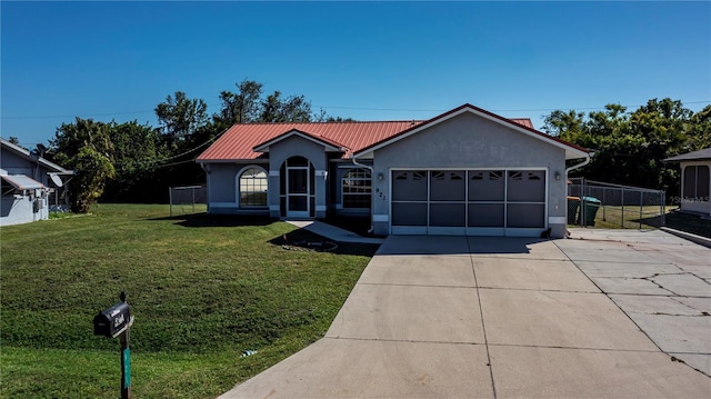 ranch-style house featuring a front lawn and a garage