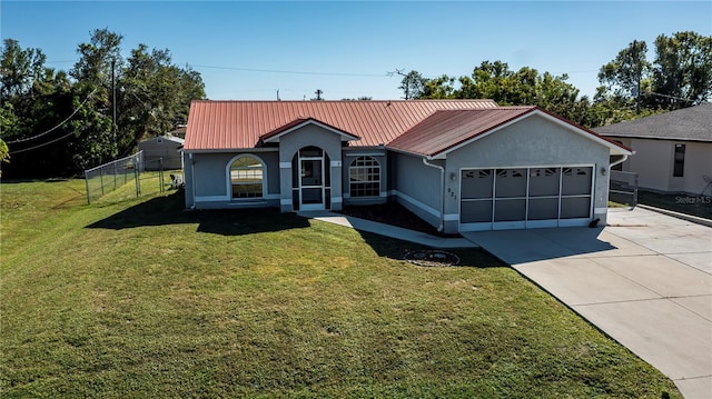 view of front of home featuring a front lawn and a garage