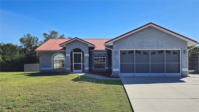 view of front of house with a garage and a front lawn