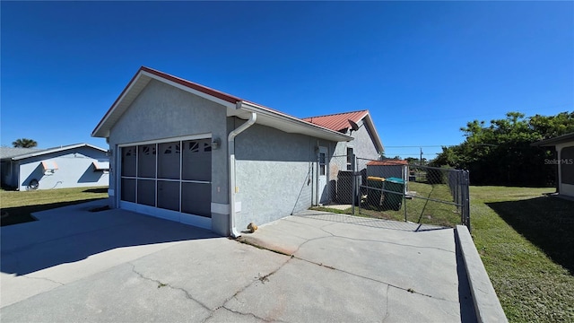 view of property exterior featuring a yard and a garage